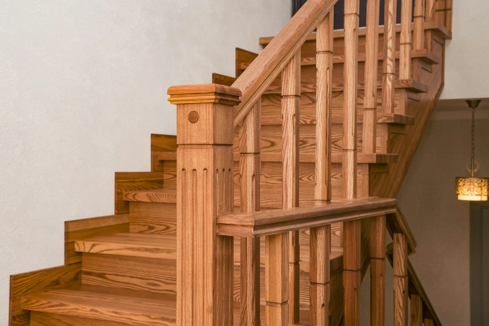 Oak staircase with turned balusters, a newel post and solid wood treads